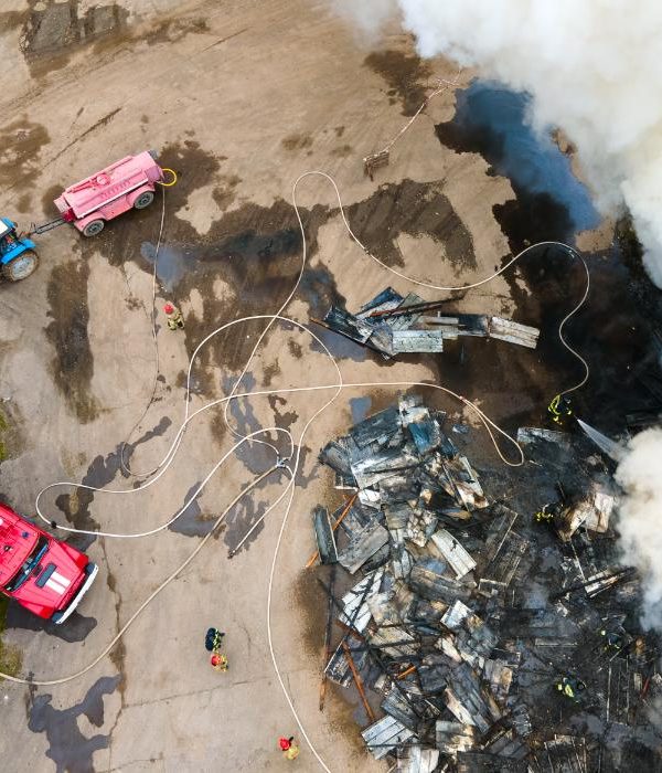 aerial-view-of-firemen-fighting-with-fire-near-old-2023-11-27-04-50-31-utc