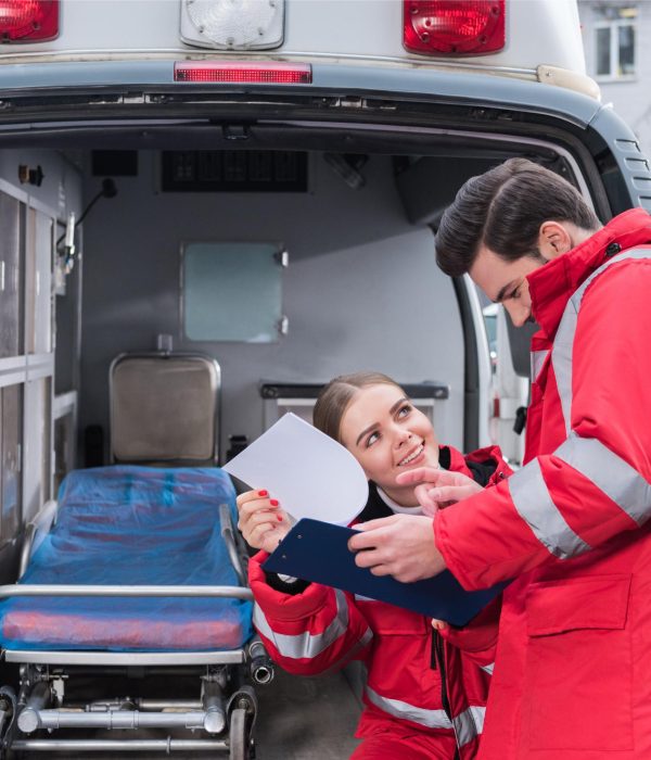 happy-male-and-female-paramedics-reading-documents-2023-11-27-05-22-15-utc (1)